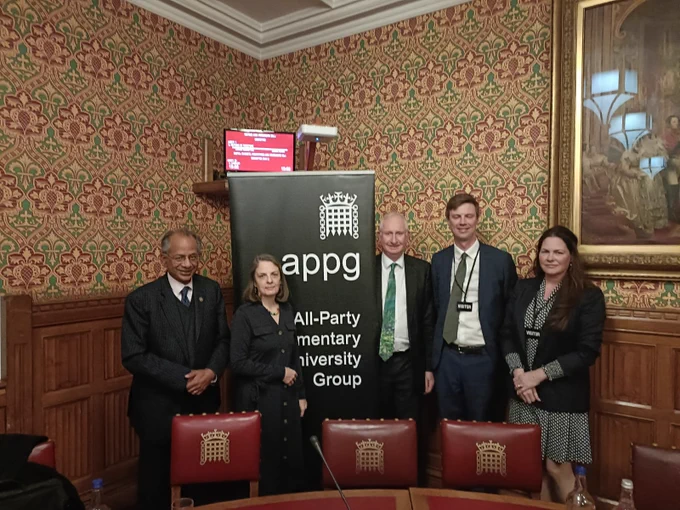 Professor Rama Thirunamachandran, Susan Lapworth, Daniel Zeichner MP, John Gill and Dr Jo Saxton posing with the All-Party Parliamentary University Group banner.