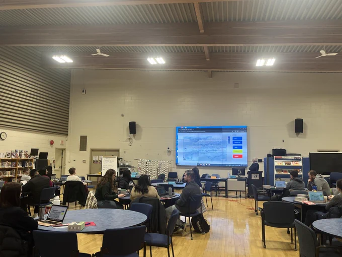 photo of educators attending a pd session with project displayed on screen