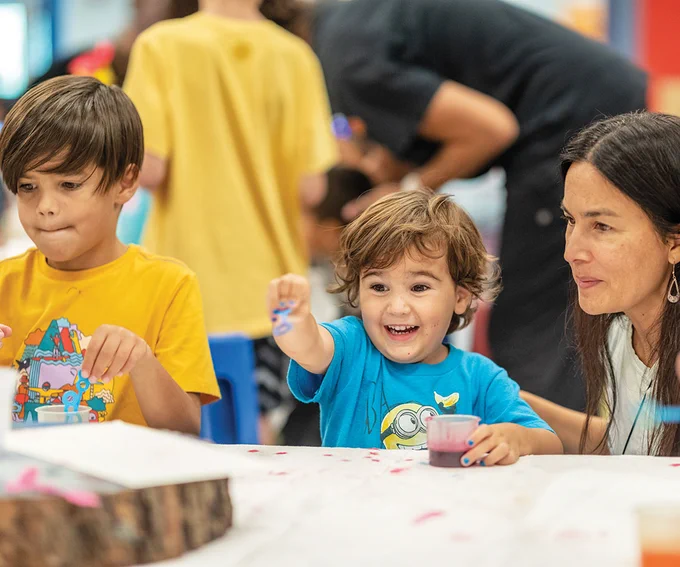 An image of two young children playing in the Questioneers exhibit.