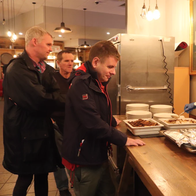 Members of the community receive meals from our counter at the Community Corner.