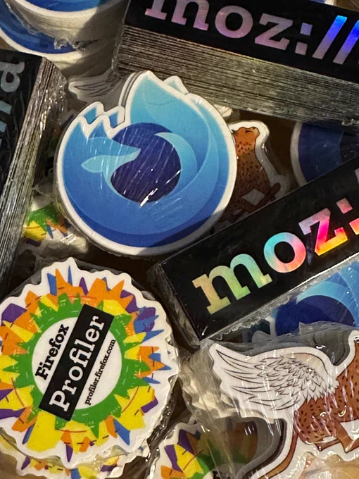Packs of stickers with designs including a shiny Mozilla logo, Firefox developer edition logo, and Firefox profiler.