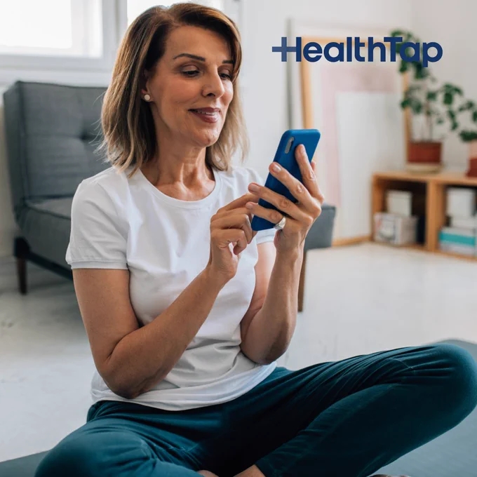 Text that says 'HealthTap' and a woman using a smartphone
