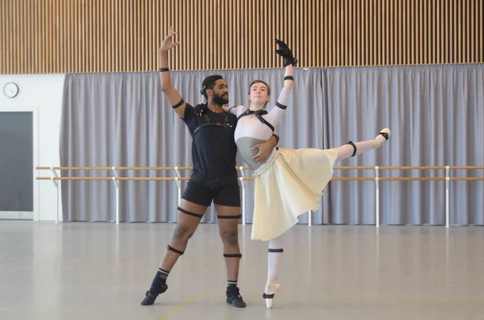 Two ballerina dancers wearing sensor suits.
