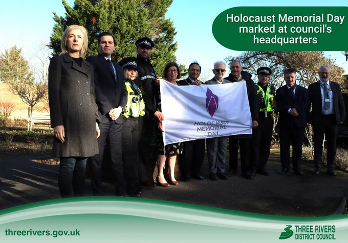 (From left) Cllr Debbie Morris, Cllr Oliver Cooper, PC Bianca Buciuta, Cllr Sarah Nelmes, Cllr Raj Khiroya, Cllr Tony Humphreys, Alan Moss, PC Conor Fountain, Cllr Stephen Cox and Cllr Chris Mitchell, standing beside the Holocaust Memorial Flag

