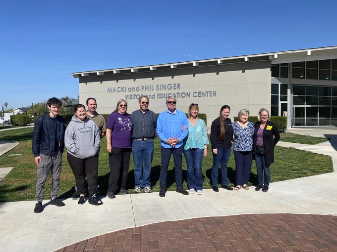 This is a group photo of ten puppy raisers.