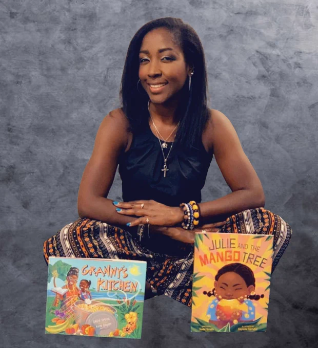 Sadé Smith pictured smiling and sitting down with her 2 children's books in front of her, Granny's Kitchen and Julie and the Mango Tree.