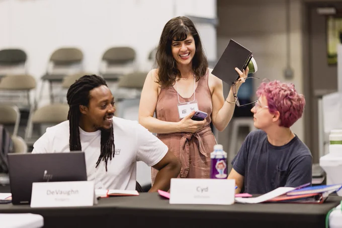 📸Group of three people engaging in workshop