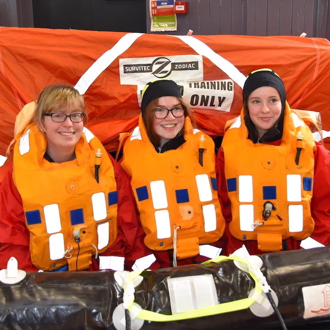Three people in a life raft