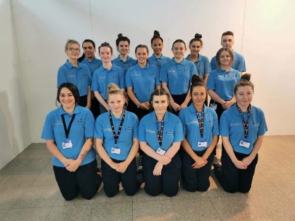 Group a young apprentices standing and sitting