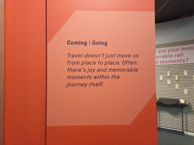 Quote on gallery wall: 'Coming / Going. Travel doesn't just move us from place to place. Often, there's joy and memorable moments within the journey itself'