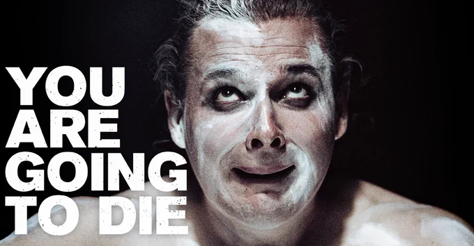 Image shows a performer in with white dust on his face and his eyes looking up. Text reads: You Are Going To Die