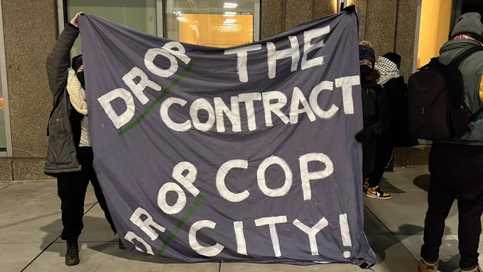 Banner saying “Drop The Contract for Cop City”