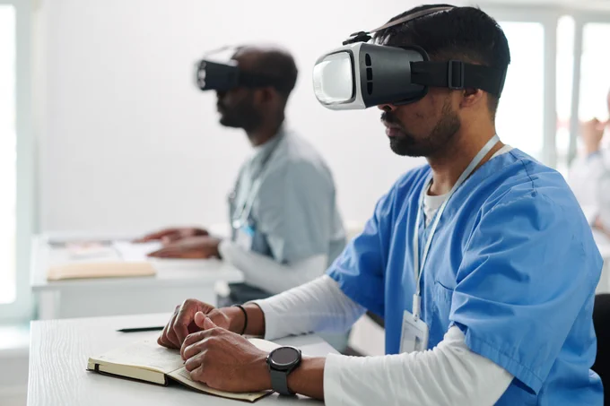 A medical professional receiving training wearing a VR headset