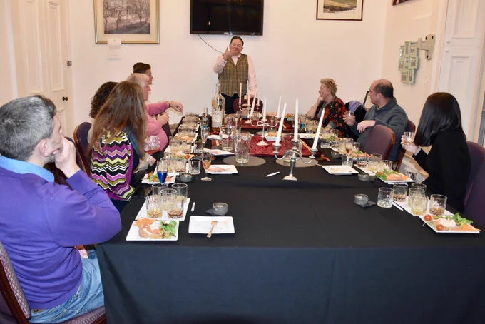 Dundee Gin Founder Peter Menzies addressing eight guests around the table