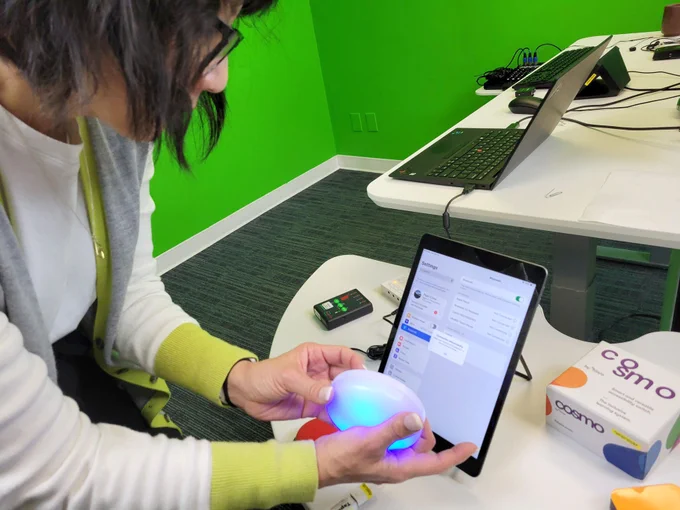 Pearl holding the cosmo switch to control the screen on a tablet.