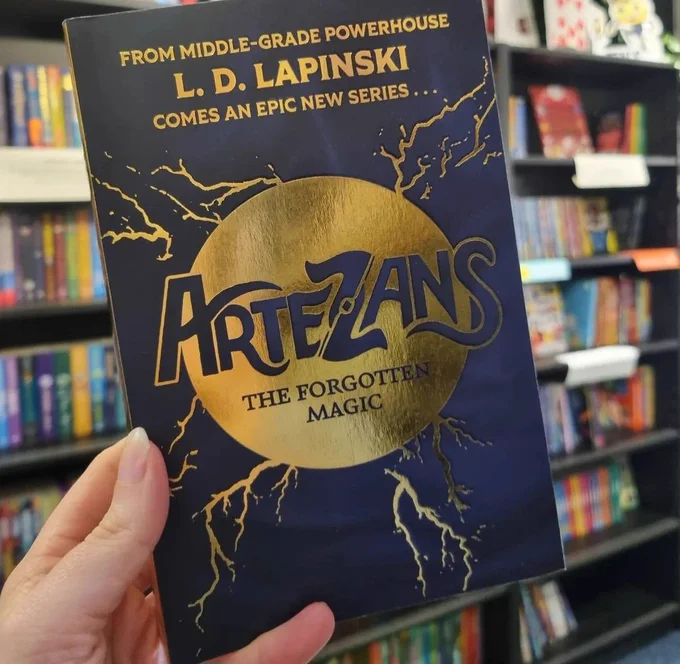 Proof copy of Artezans being held up in Wonderland Bookshop 