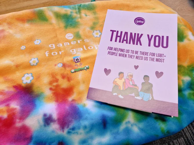 A rainbow hoodie that says gamers for galop, and a card that says thank you