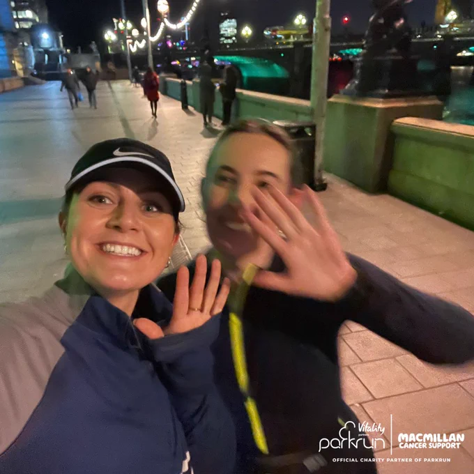 Image of a two women with their hands up for a high five
