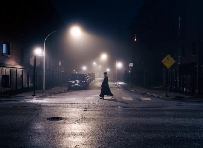 photograph of a woman crossing the street