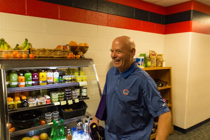 Otis smiles in front of a food stand in the Cubs locker room.