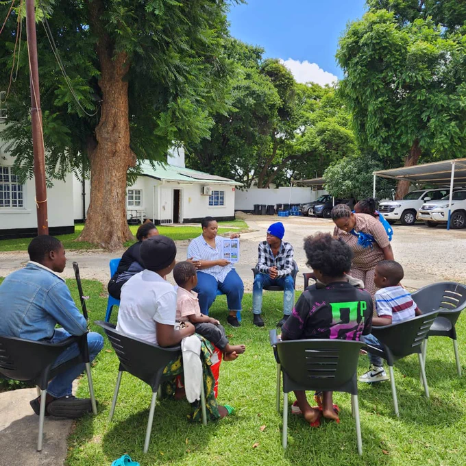 IOM staff providing a pre-departure briefing to migrants on resettlement