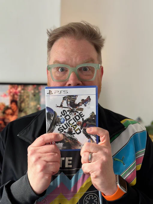 It's me, holding up the PS5 version of Suicide Squad: Kill the Justice League.