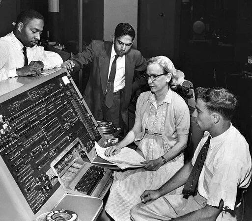 The mother of computer programming; Grace Hopper at the UNIVAC keyboard, c. 1960 Unknown (Smithsonian Institution), CC BY 2.0, via Wikimedia Commons