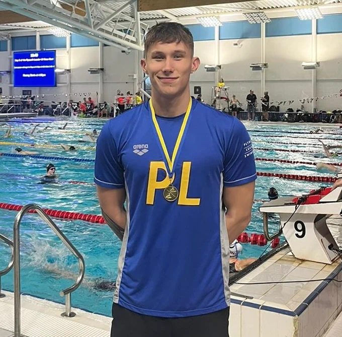 Harry Stewart smiles poolside.
