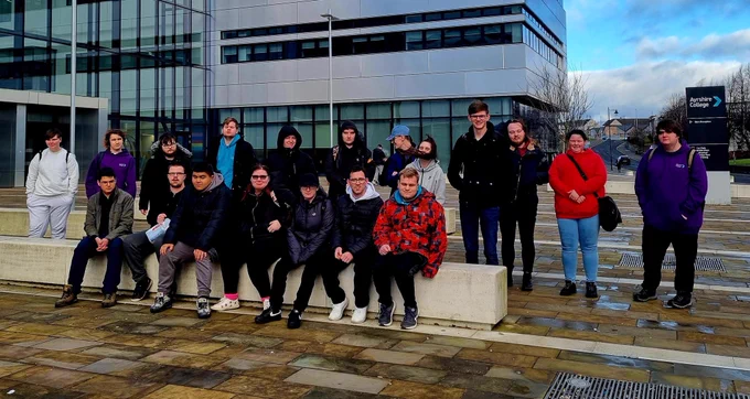 Group@of happy students standing outside college