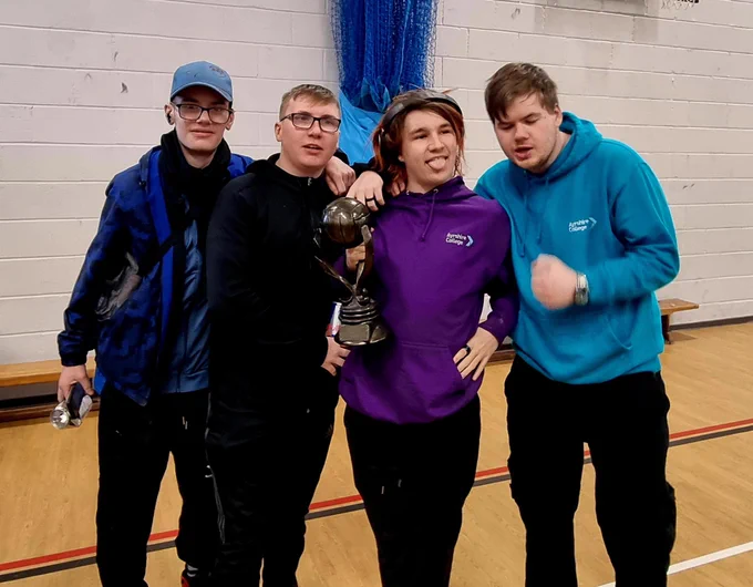 Group of students holding a trophy