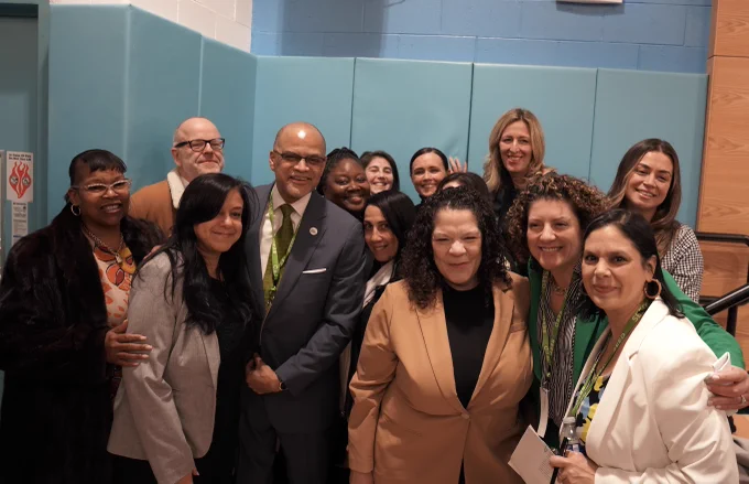 Chancellor Banks poses for a group photo with N Y C Public Schools staff and administration at PS 958 for a Special Education Announcement.