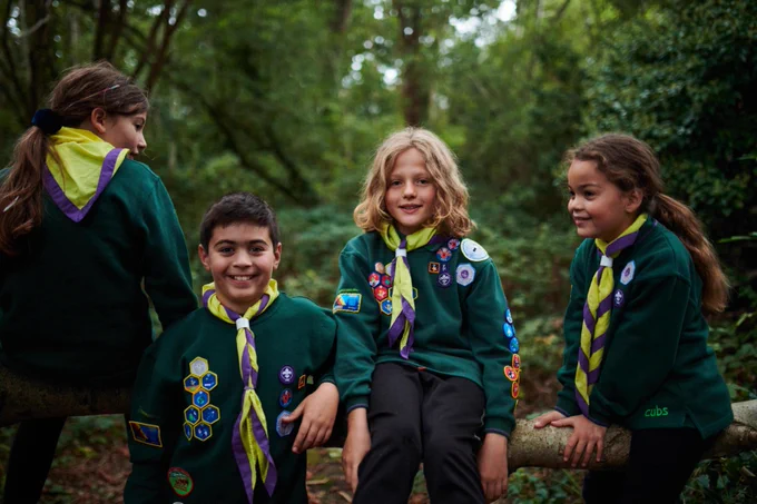 Four young people outdoors.