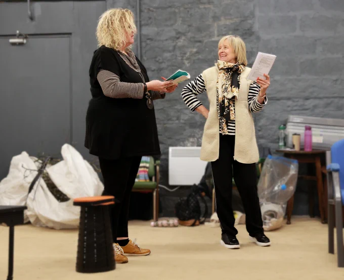 Two actresses - one looking very pleased with herself, but we know that's not going to last - rehearse for Sheila's Island, 13-16 March Longwood Mechanics Hall