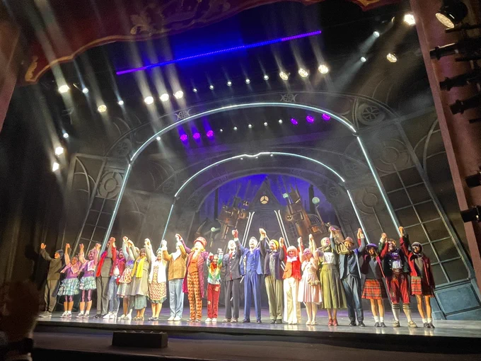 The cast onstage bowing at the end of the show during a curtain call.