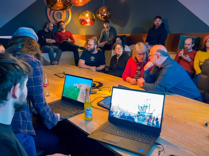 A group of our guests gathering in a meeting room for a presentation on Anno concept art.