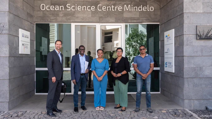 Five people standing in front of a building named 'Ocean Science Centre Mindelo'