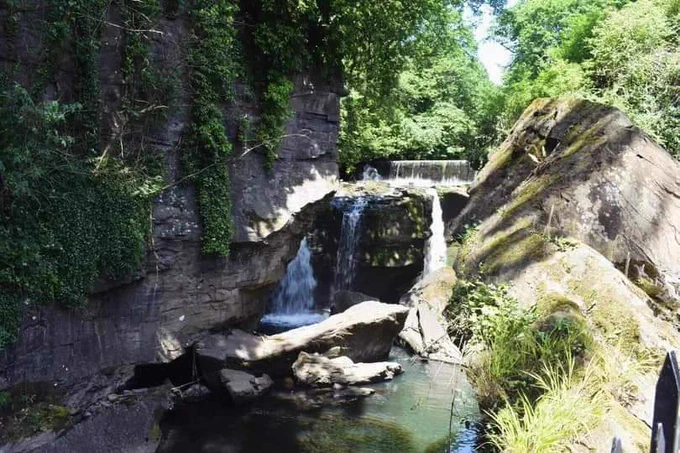 Aberdulais waterfall with a light flow in a sunny day.