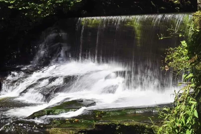 Close up of the waterfall at Aberdulais Tinworks on a sunny day. 