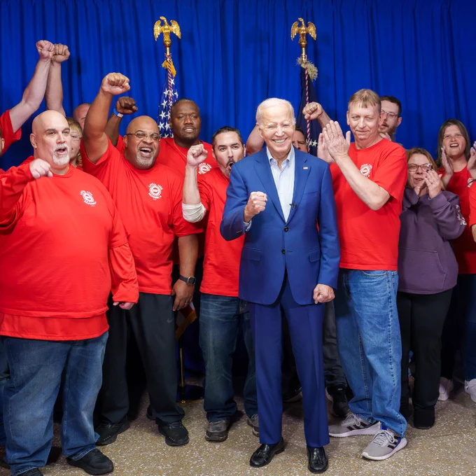 President Joe Biden takes a photo with union members.