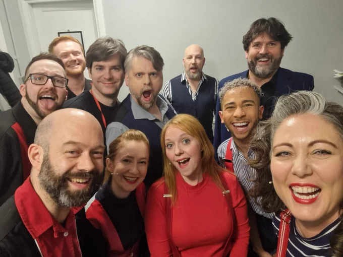 The Showstopper cast, band and Damian smile for the camera in a selfie backstage.