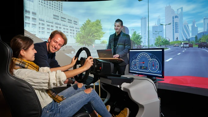Photograph of people in the transport simulator at a laboratory in Cardiff University’s School of Psychology.