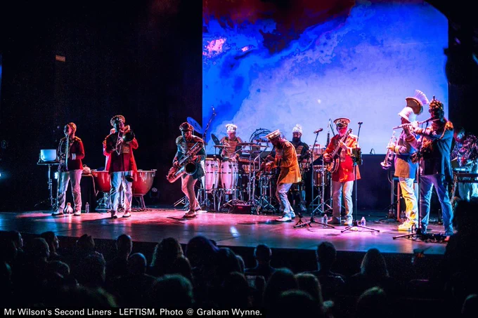 Photo of a band performing on a stage