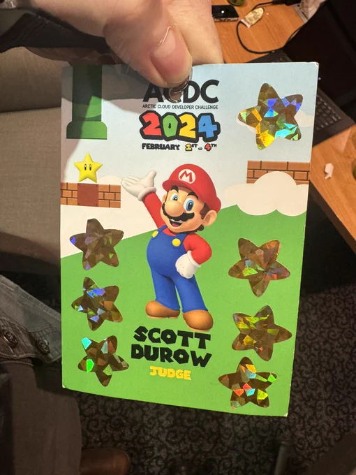 ACDC badge showing Mario with Scott Durow Judge written underneath