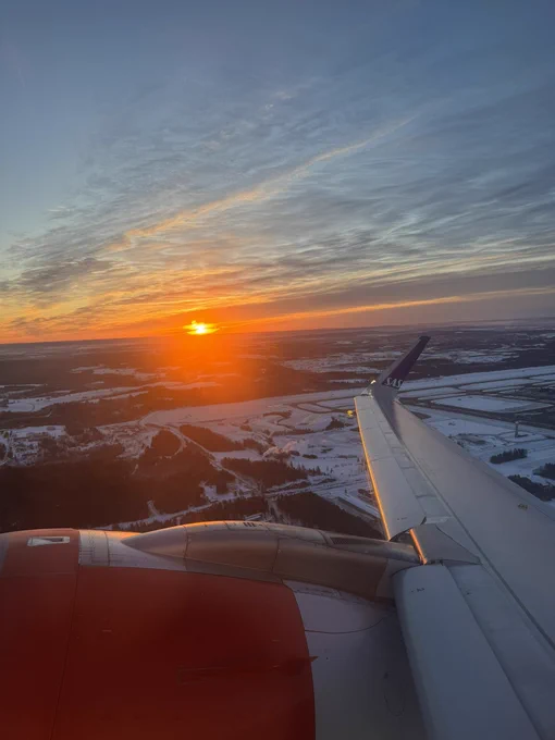 Sunrise from my flight above the snowy landscape of Norway