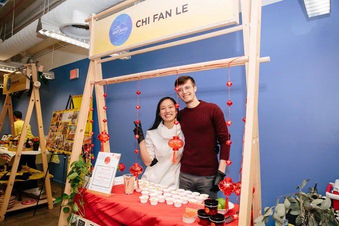 The owner of Chi Fan Le smiles at her booth display at the 2023 Comerica Hatch Detroit Contest Top 10 Reveal