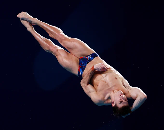 Ross Haslam mid-twist as he performs a twisting dive in the Men's 3m Springboard final