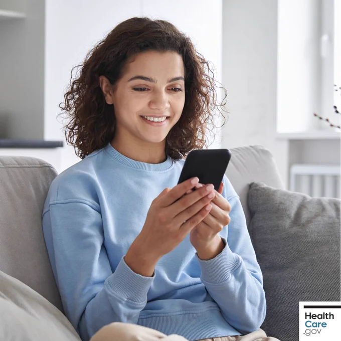 A woman using her phone to make a doctor's appointment.