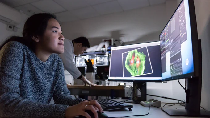 Image of a student reading from a computer.
