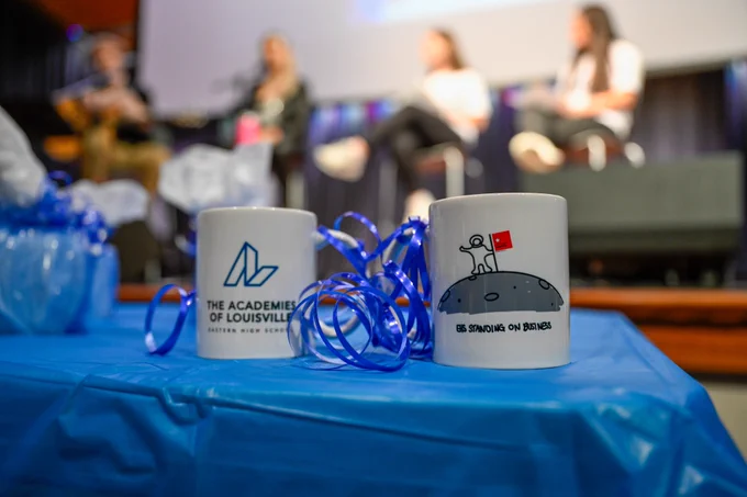 Two mugs sit on a table.
