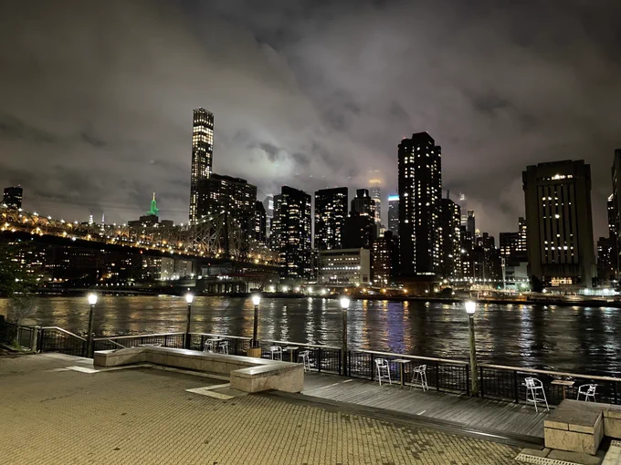 Nighttime view of buildings in NYC with low cloud
